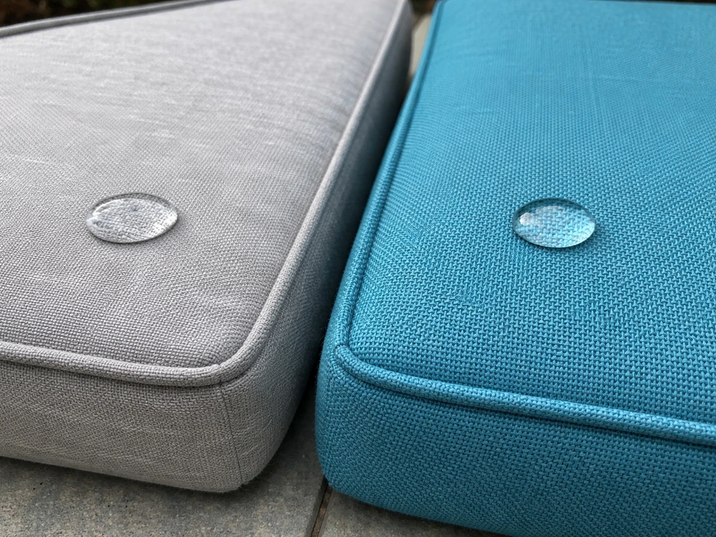 Close-up comparison of outdoor swing fabrics: solution-dyed acrylic beads water, polyester shows dull fading.