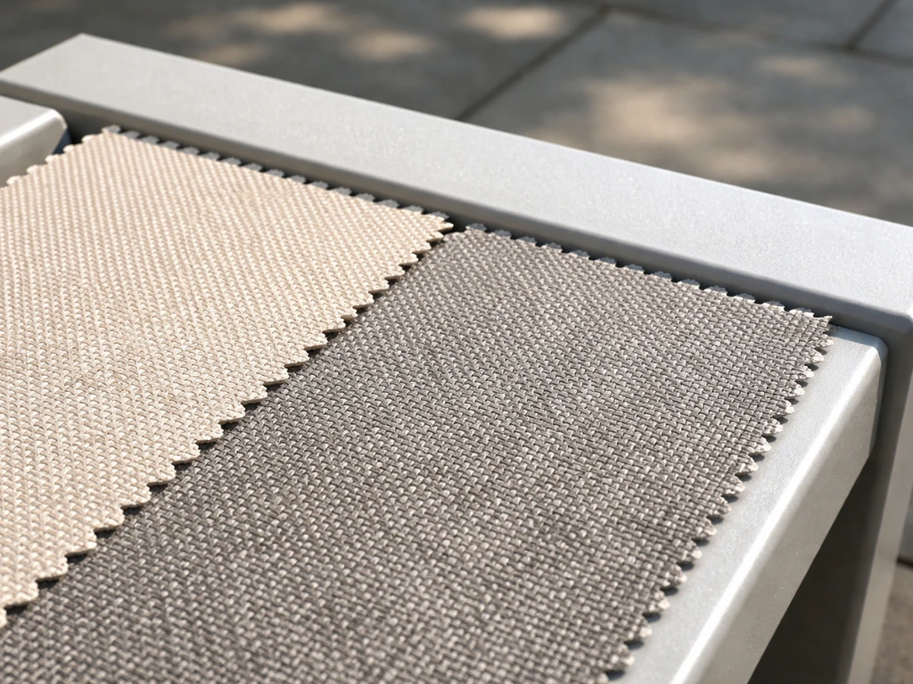 Outdoor fabric swatches beside a powder-coated aluminum frame section, showing weather-ready textures.